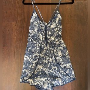Never worn romper blue and white pattern. Adjustable straps
